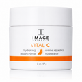 A white cosmetic jar of Image Skincare Vital C hydrating repair crème with orange and black text, set against a clean white background with a subtle reflection.