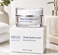 Obagi Hydrate Luxe Moisture-Rich Cream jar on a white box with a bathroom setting.