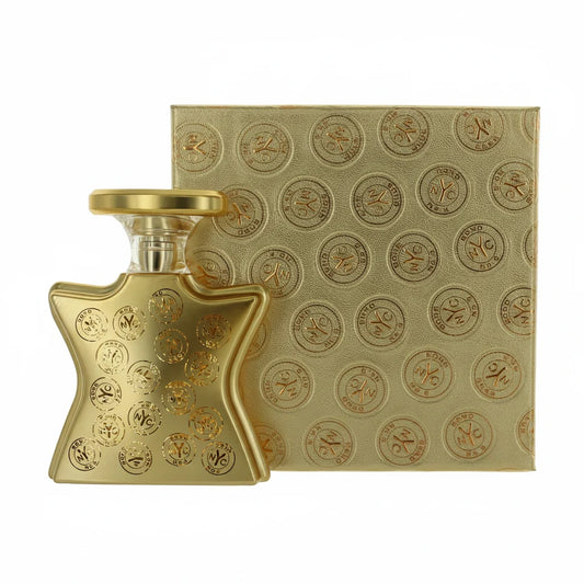 Gold perfume bottle and packaging with a pattern on a white background